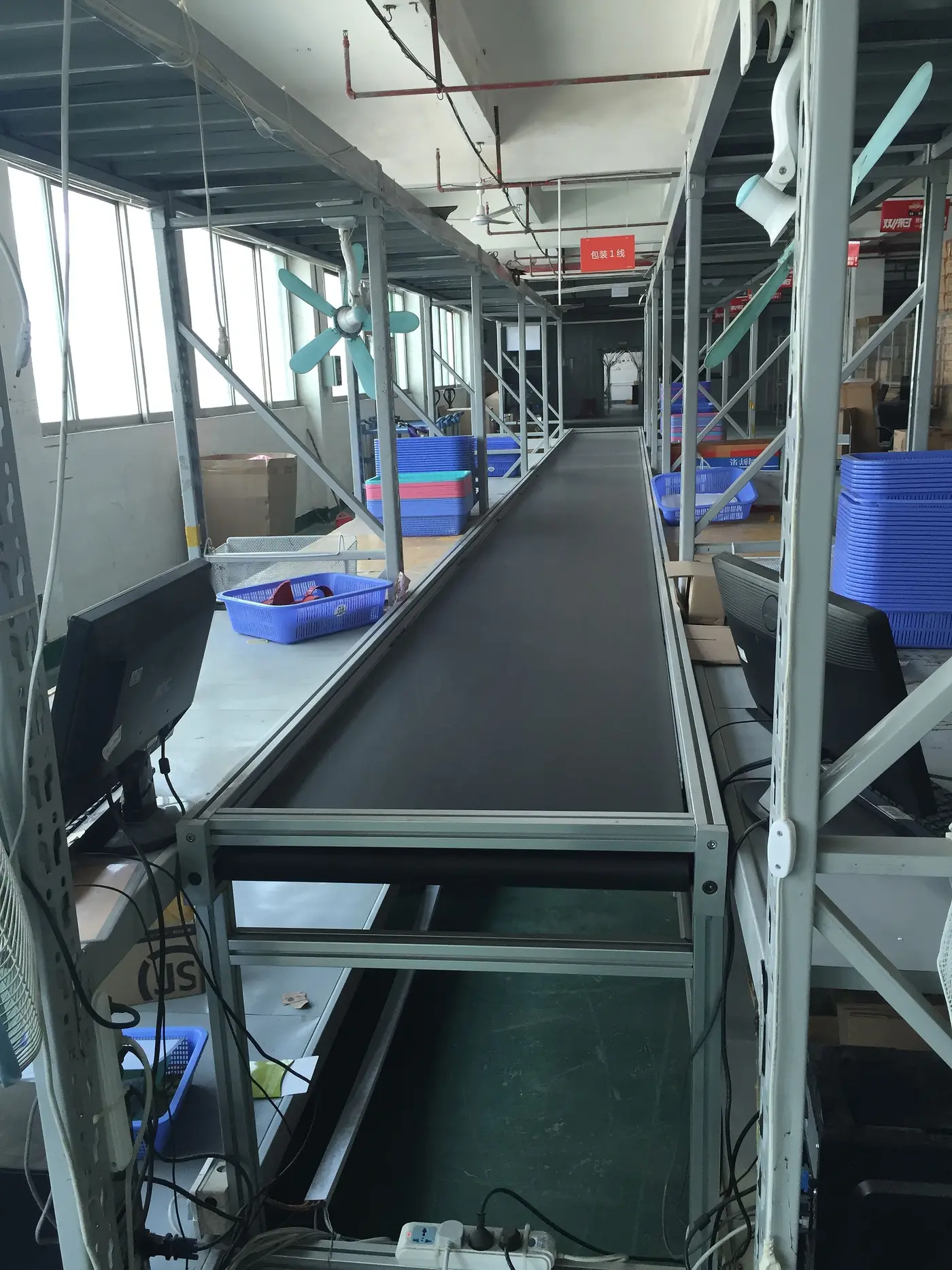 The parcel conveyor and scanning desks in our warehouse