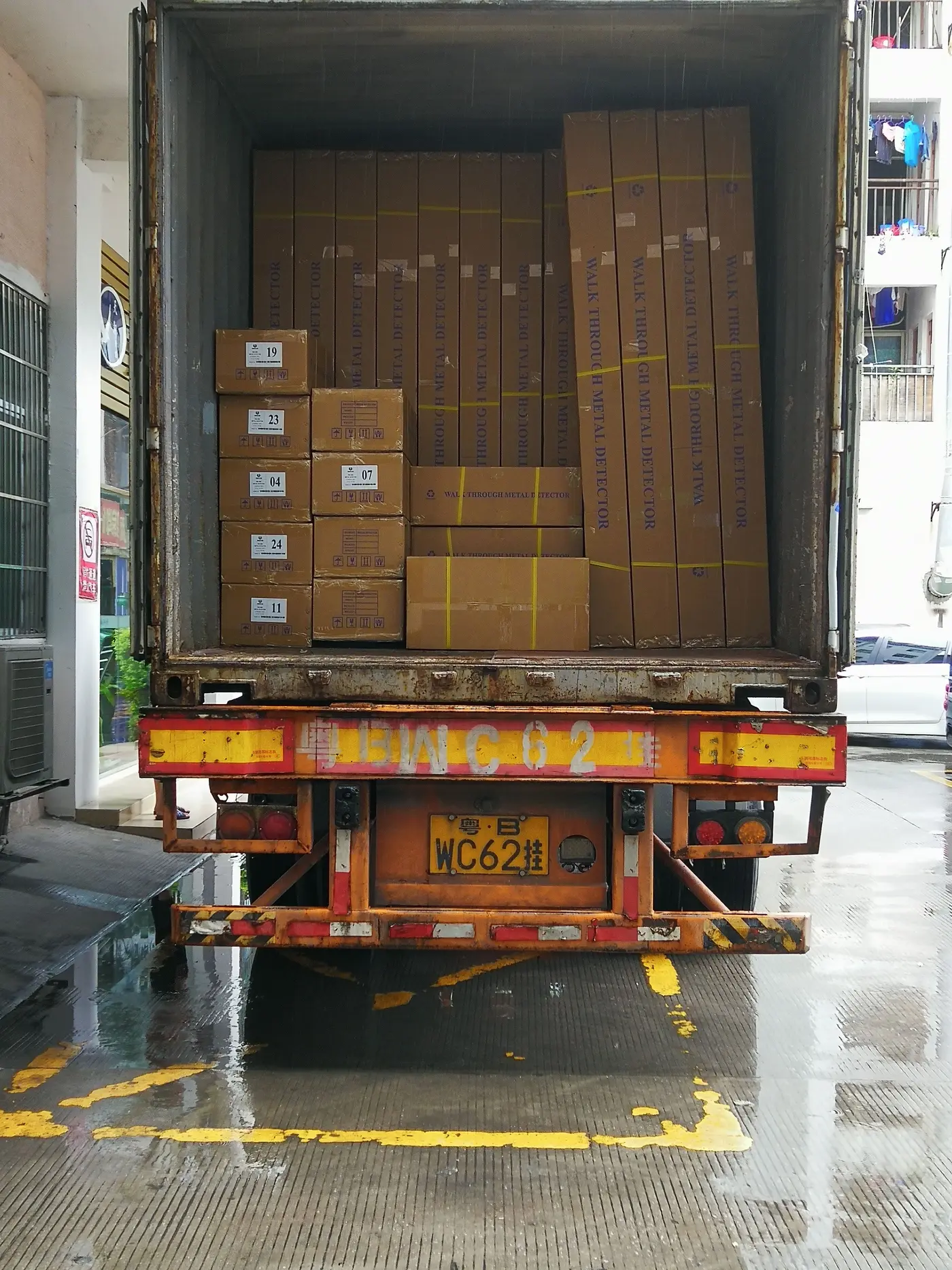 A truck full of cartons, open for unloading