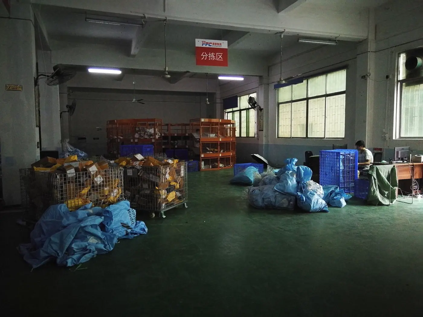 The sorting area of our Shenzhen warehouse, with parcels in cages and bags
