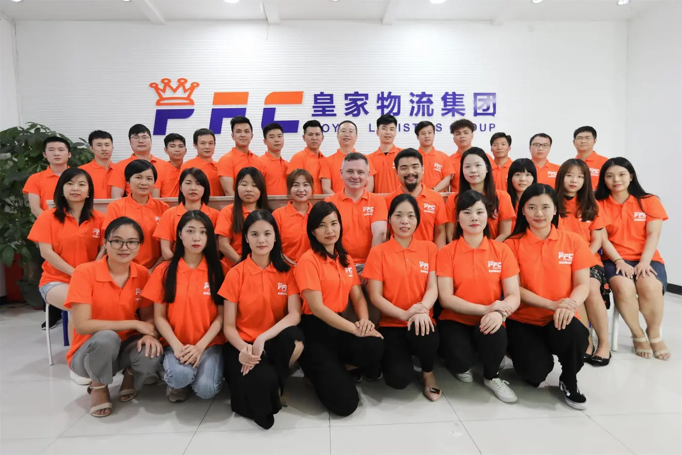 The PFC team in orange shirts at the Shenzhen office, 2020