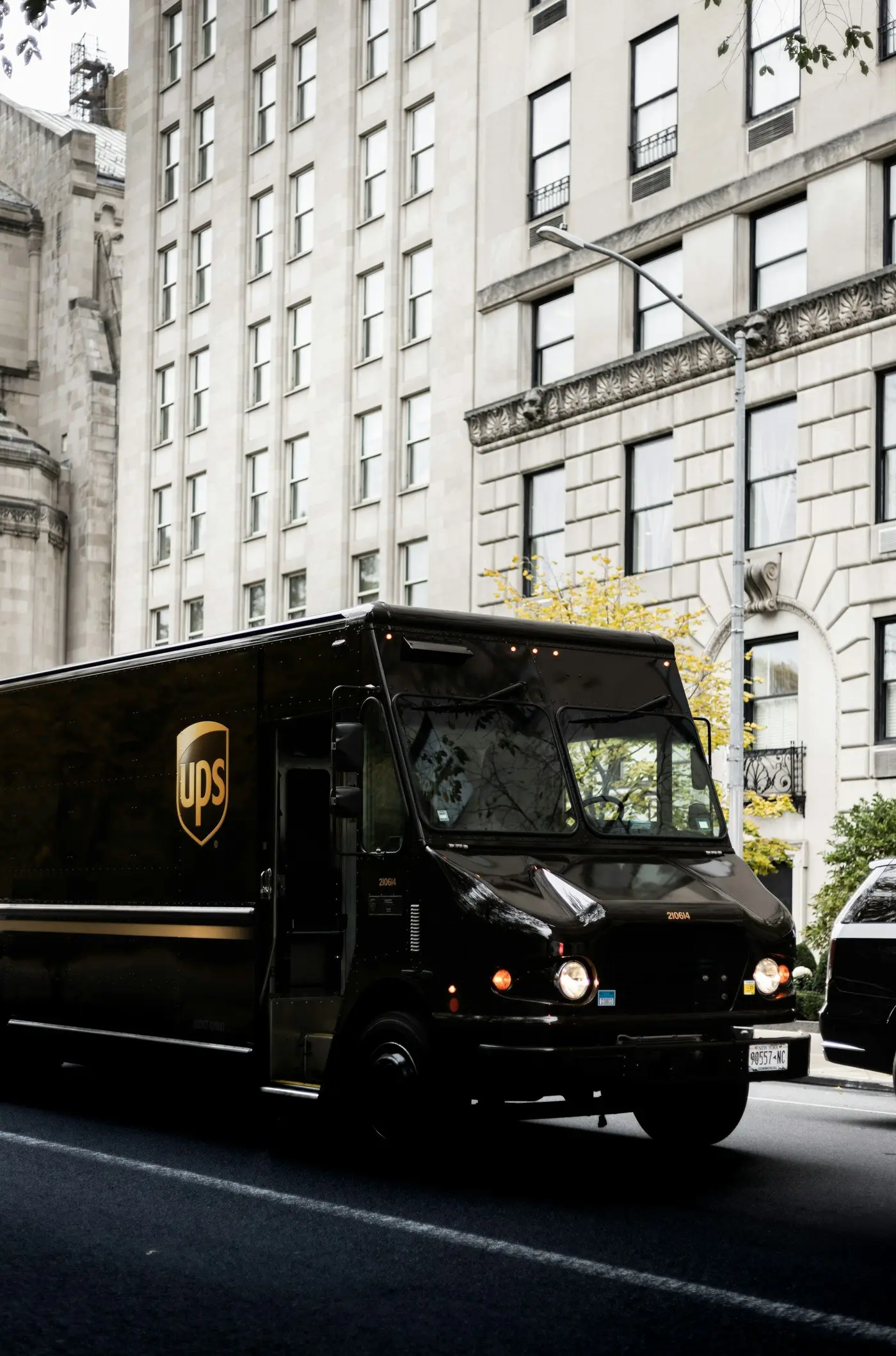 A brown UPS truck on a city street