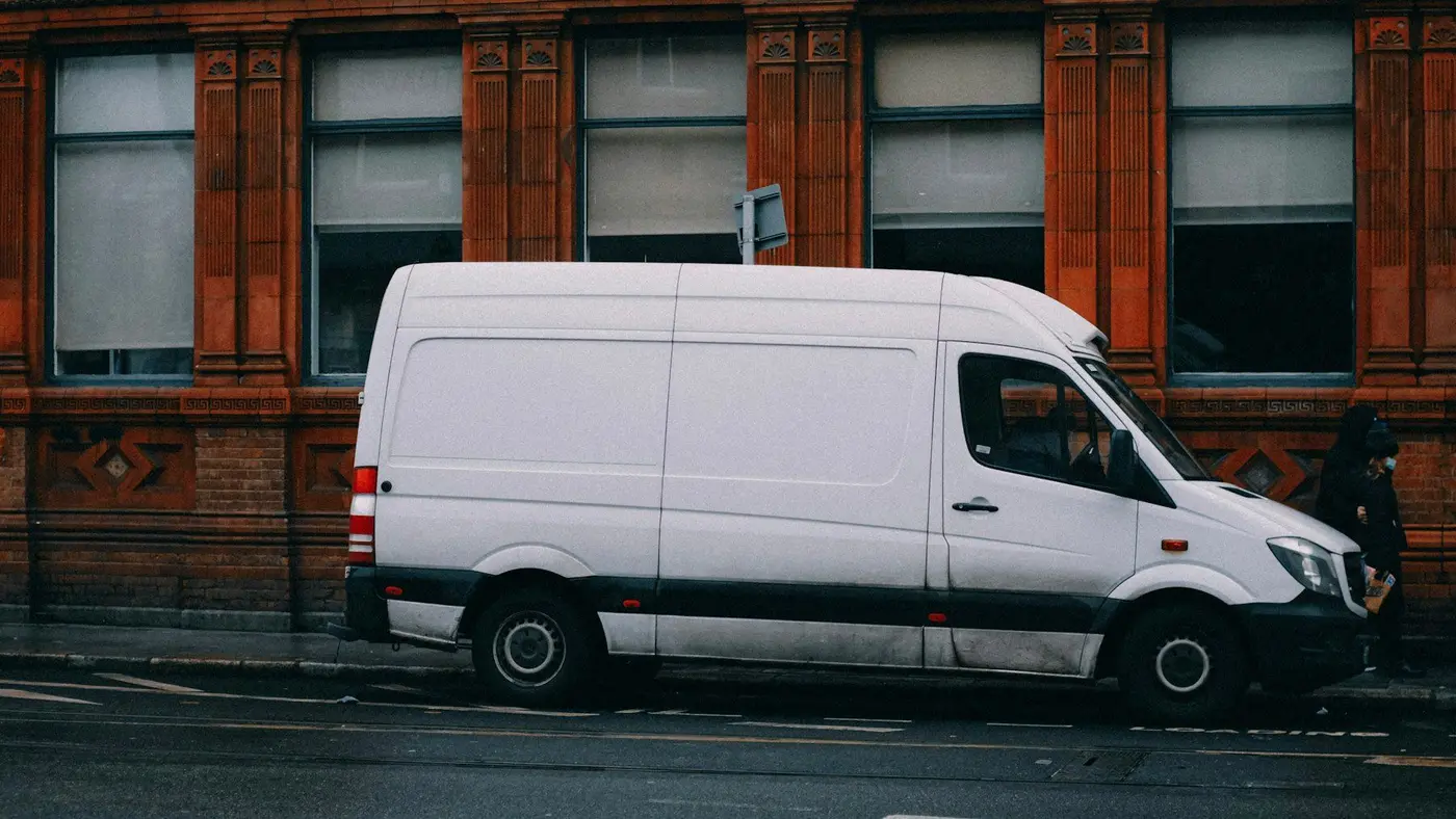 A white delivery van parked on a street
